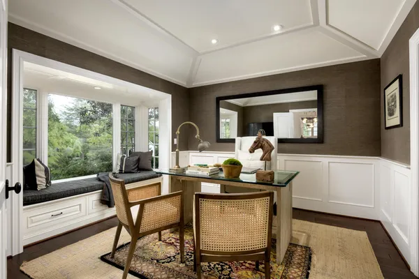 a dining room with furniture and a floor to ceiling window