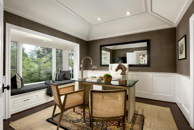 a dining room with furniture and a floor to ceiling window