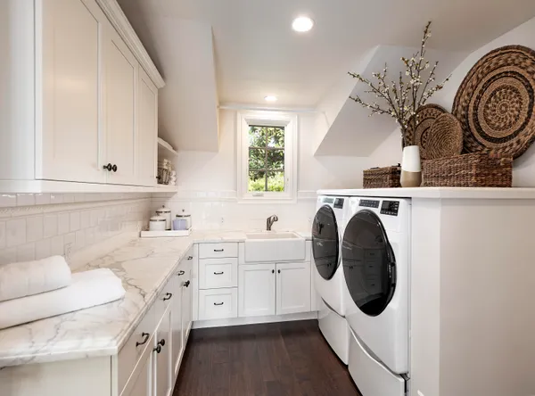 a kitchen with a sink a stove and cabinets