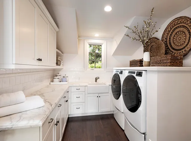 a kitchen with a sink a stove and cabinets