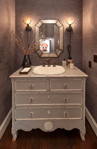 a bathroom with a sink vanity and mirror
