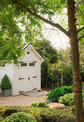 a view of a house with a tree in front of it