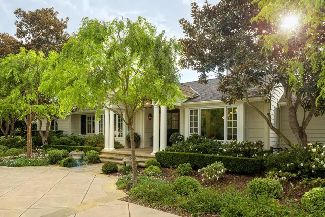 a front view of a house with a garden