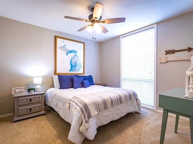 1957 Deer Trail Road Graford, TX 76449 - Photo 20 of 32 a bedroom with a bed and a chandelier