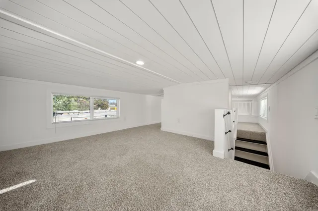 en empty room with stairs and white walls