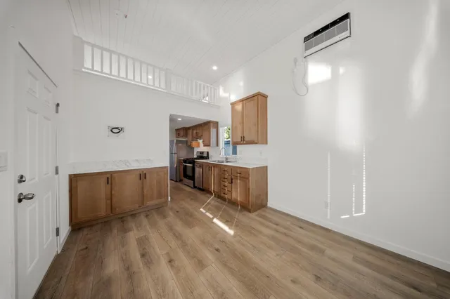 a kitchen with stainless steel appliances a refrigerator and a stove top oven