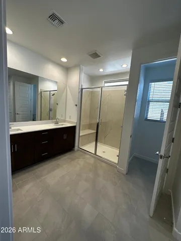 a spacious bathroom with a mirror a double vanity sink and a mirror