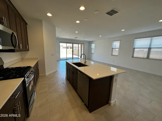 a kitchen with sink cabinets and stove