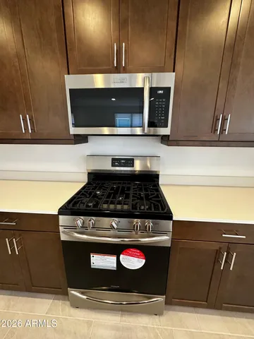 a stove top oven sitting inside of a kitchen