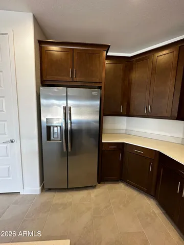 a kitchen with a refrigerator and cabinets