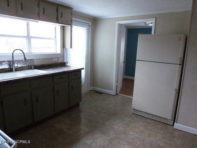 296 Sandlin Road Beulaville, NC 28518 - Photo 7 of 22 Kitchen with door to laundry room behind refrigerator.
