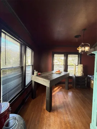 a room with furniture pool table wooden floor and a window