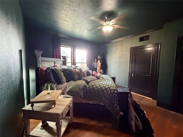 a spacious bedroom with a bed and a chandelier