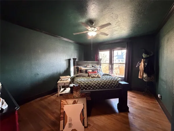 a bedroom with a bed and a chandelier