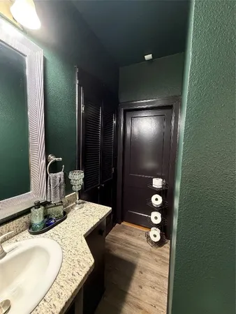 a bathroom with a granite countertop sink a toilet and shower