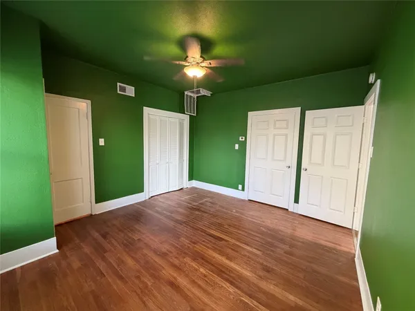 a view of a livingroom with a chandelier fan and a kitchen
