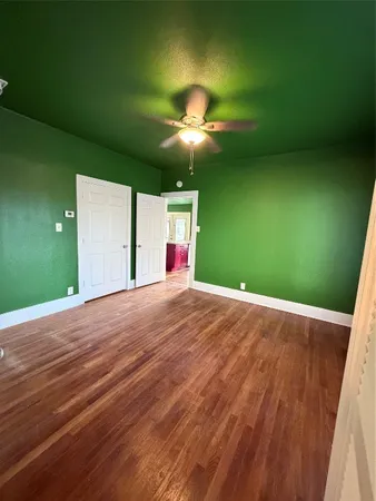 a view of empty room with fan and window