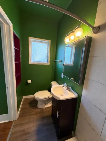 a bathroom with a toilet sink and mirror