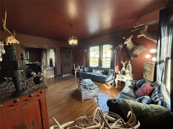 a living room with furniture and a mirror