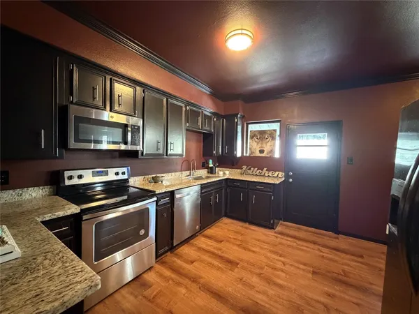 a kitchen with stainless steel appliances granite countertop a stove and a sink