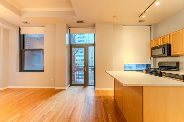 a kitchen with stainless steel appliances a refrigerator and a stove top oven