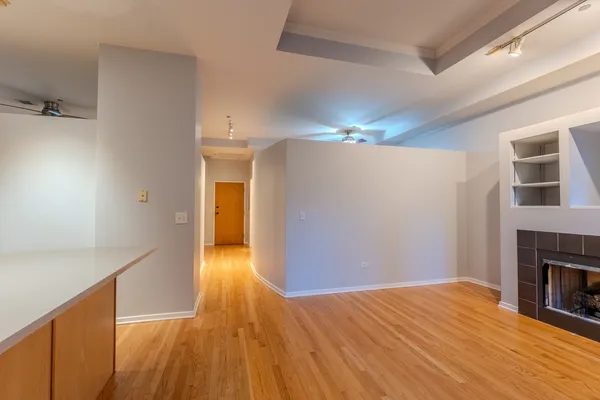a view of empty room with wooden floor