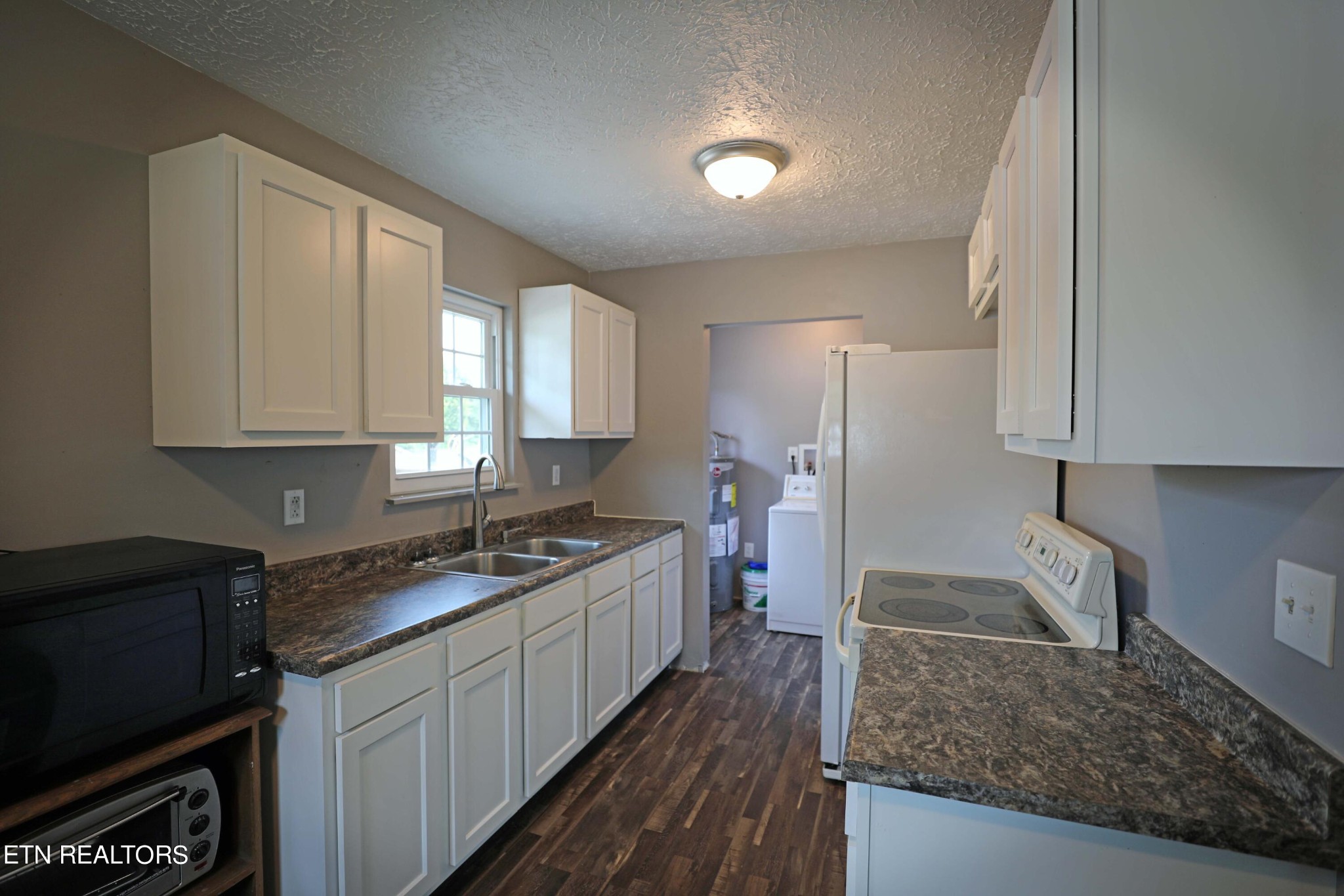 7816 Majors Road Corryton, TN 37721 - Photo 6 of 13 a kitchen with stainless steel appliances granite countertop a sink stove and refrigerator