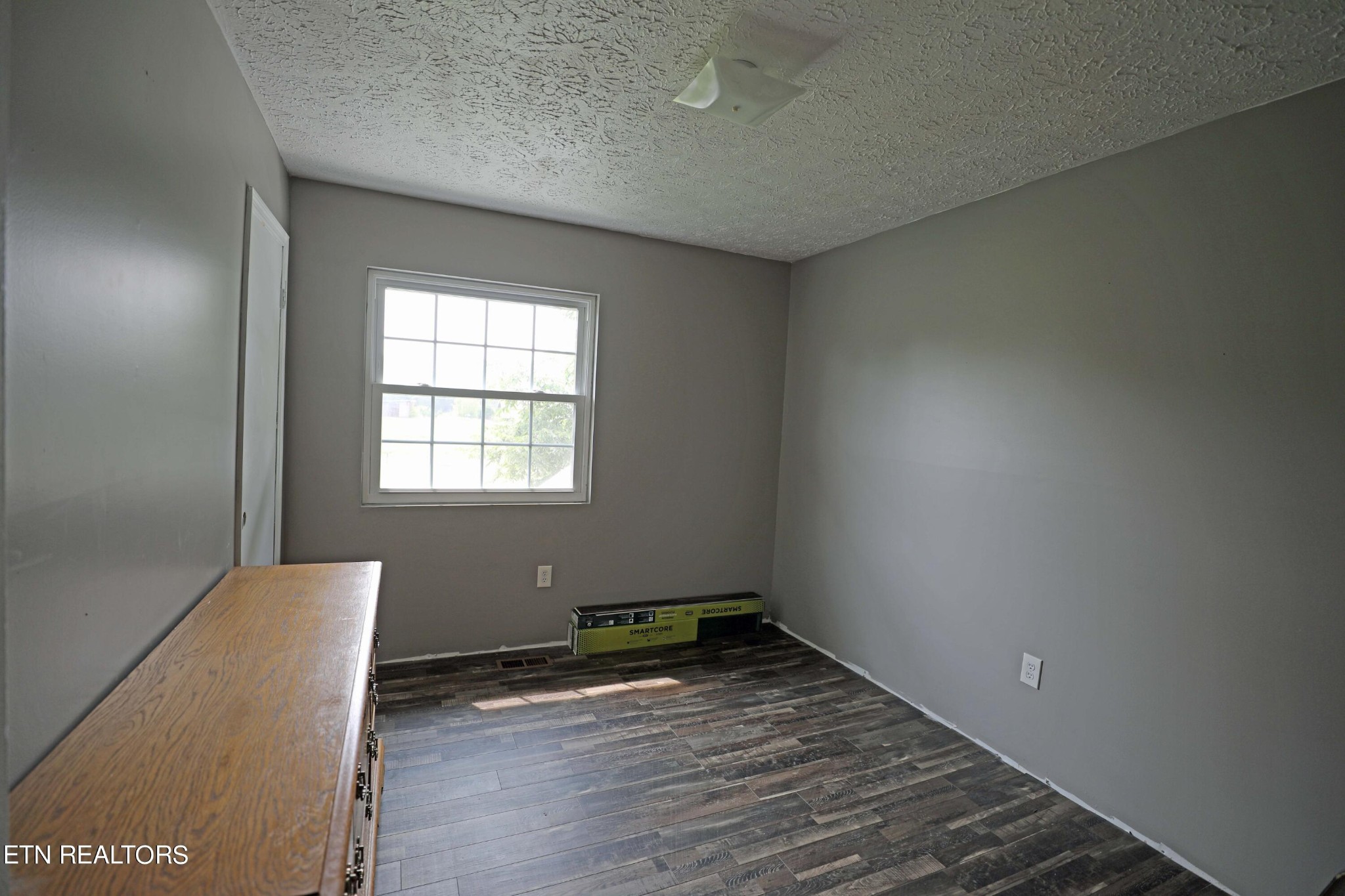 7816 Majors Road Corryton, TN 37721 - Photo 8 of 13 an empty room with wooden floor and windows