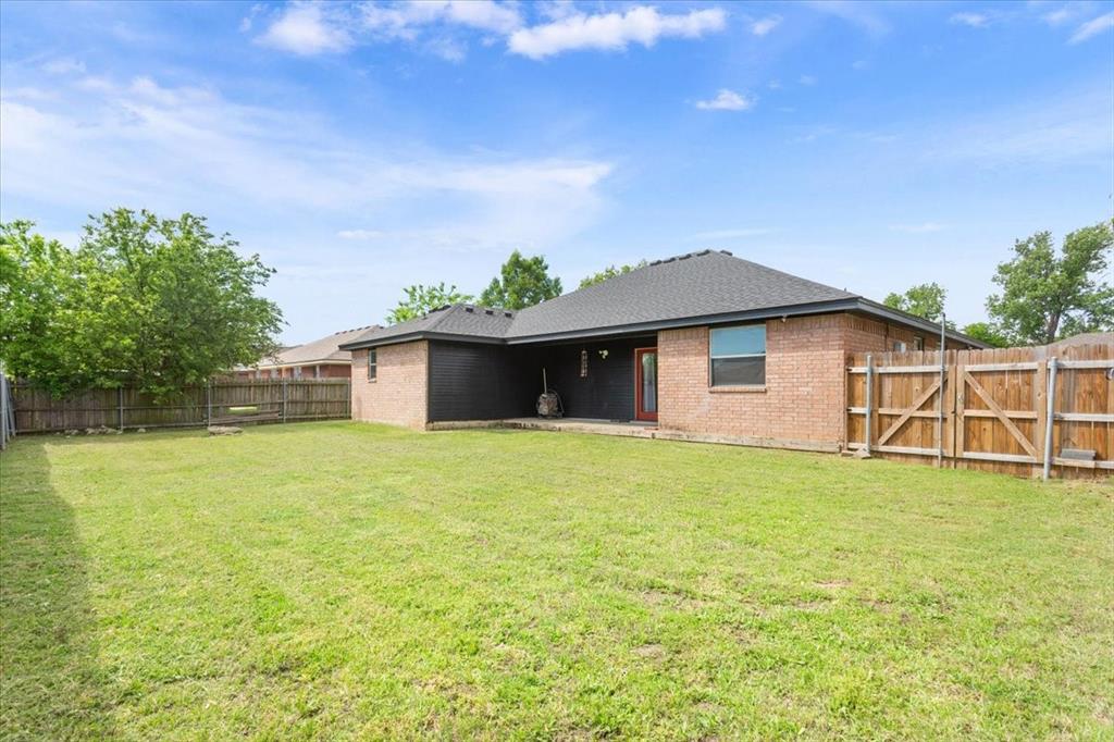 10817 Lilry Road Waco, TX 76708 - Photo 26 of 27 Rear view of house with a patio, brick siding, a fenced backyard, a gate, and roof with shingles