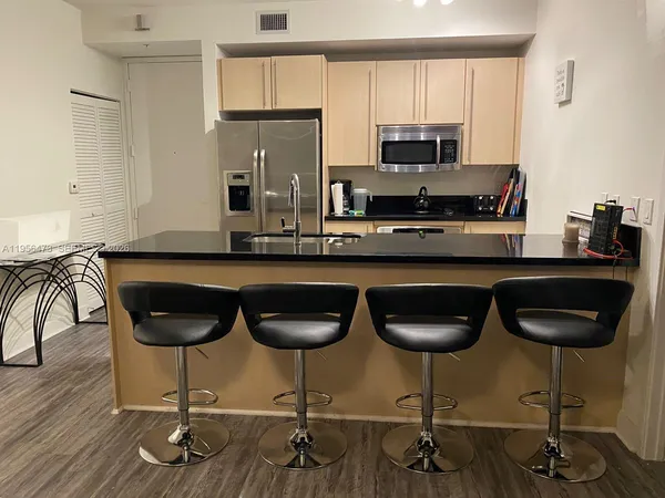 a kitchen with a dining table and chairs
