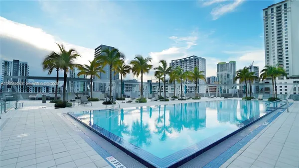 a view of swimming pool with outdoor seating and plants