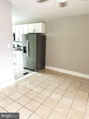 a kitchen with stainless steel appliances a refrigerator and a stove top oven