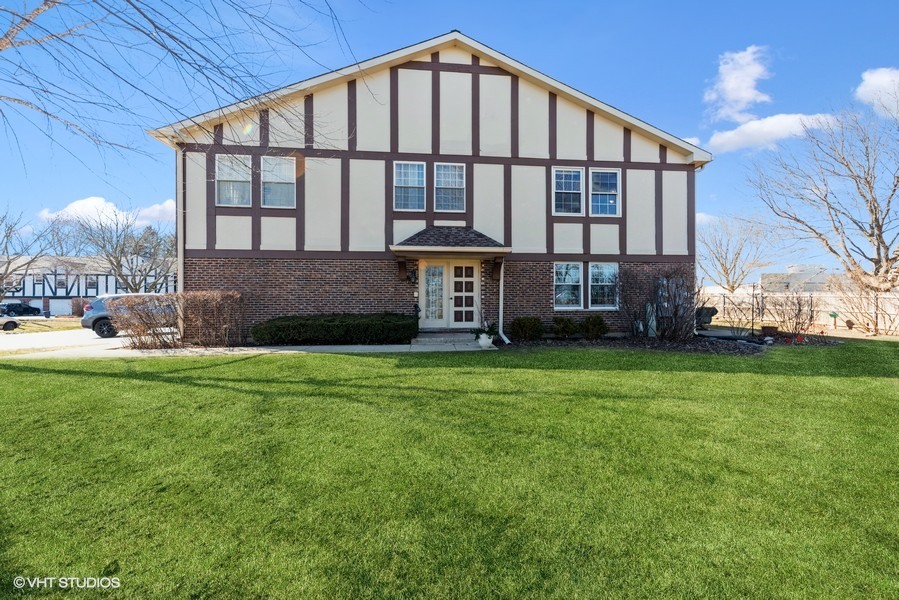 138 West Golf Road, Unit B Libertyville, IL 60048 - Photo 1 of 1 a front view of a house with a garden