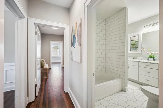 a bathroom with a granite countertop toilet sink and mirror