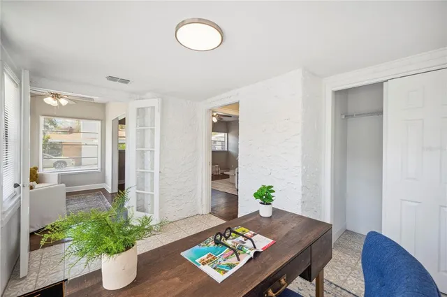 a view of a workspace with furniture and a potted plant