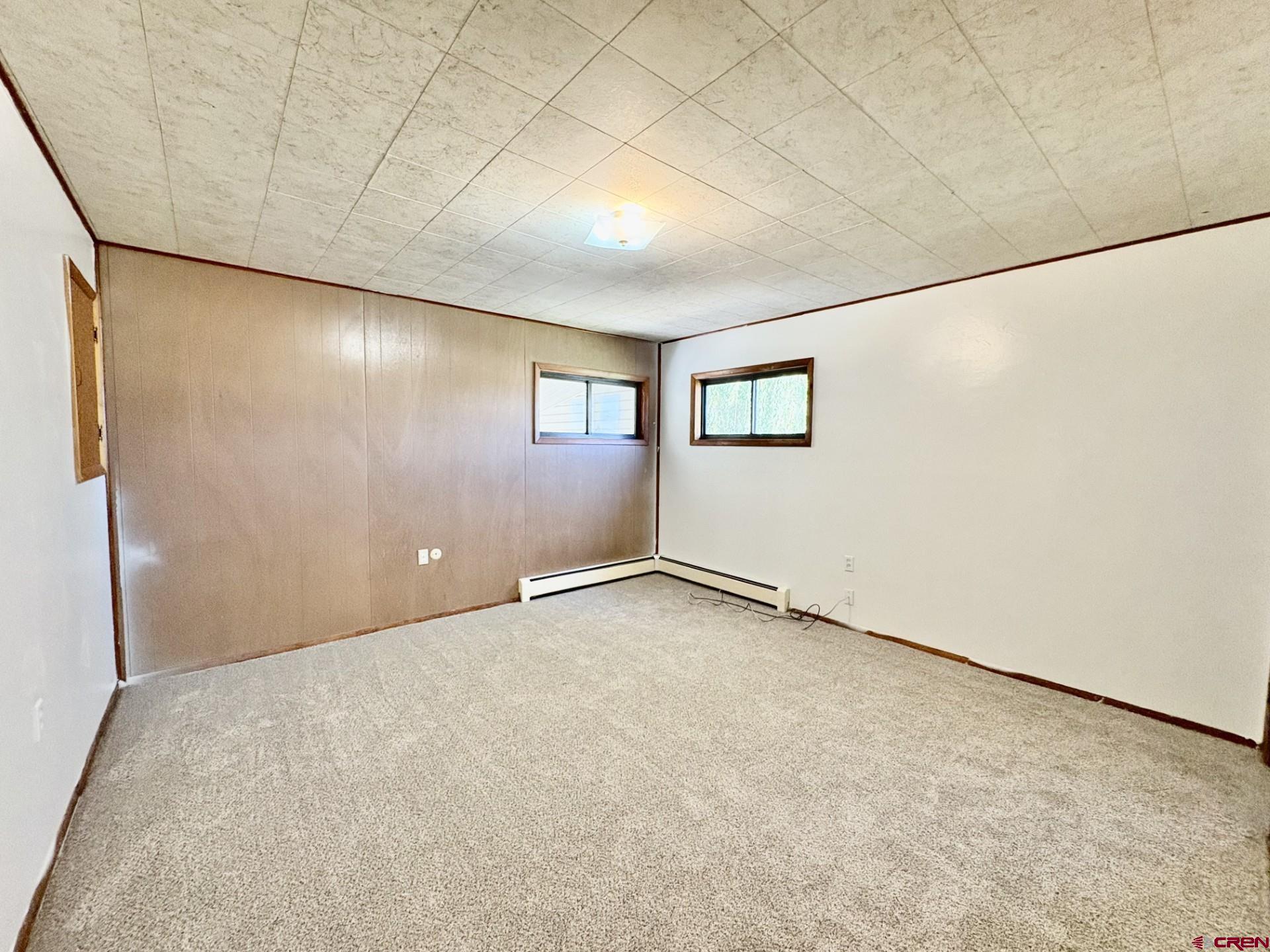 1738 East 7th Street Delta, CO 81416 - Photo 22 of 38 an empty room with a projector and a window