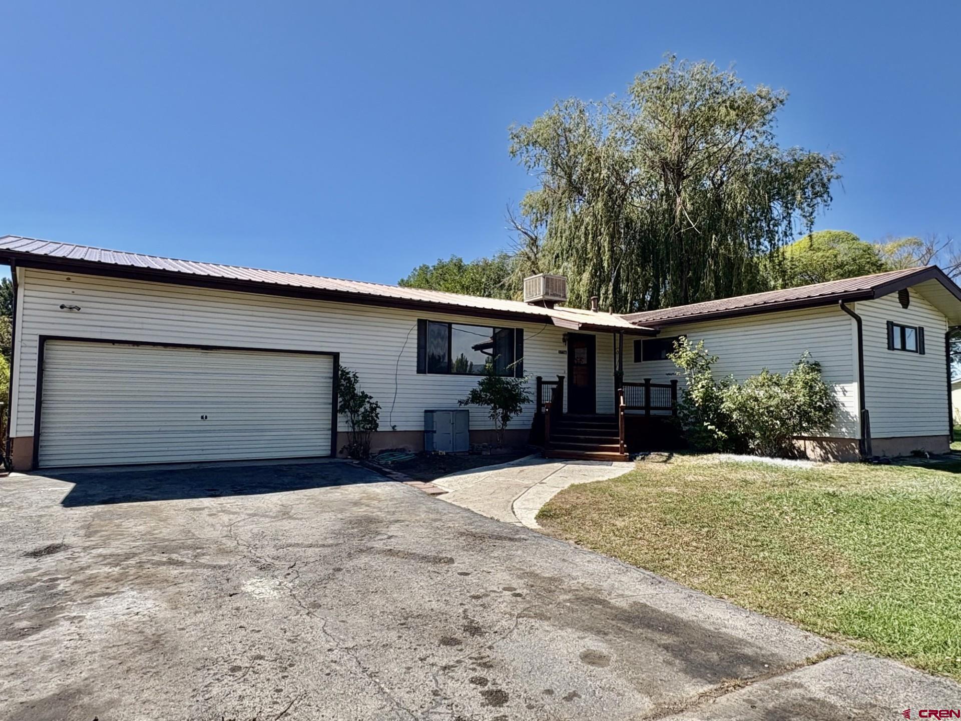 1738 East 7th Street Delta, CO 81416 - Photo 3 of 38 a view of a house with a yard and garage
