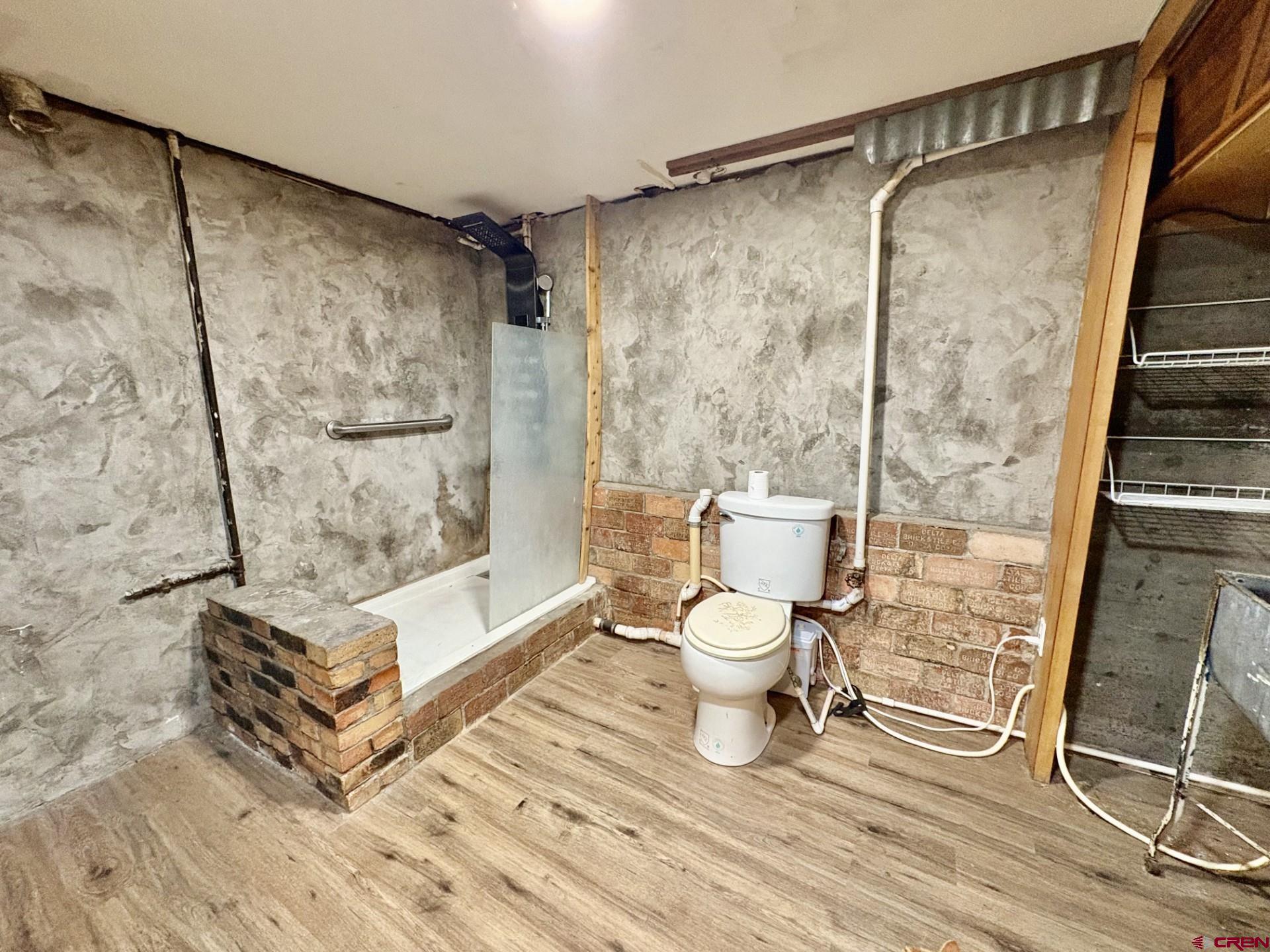 1738 East 7th Street Delta, CO 81416 - Photo 32 of 38 a bathroom with a toilet and a shower