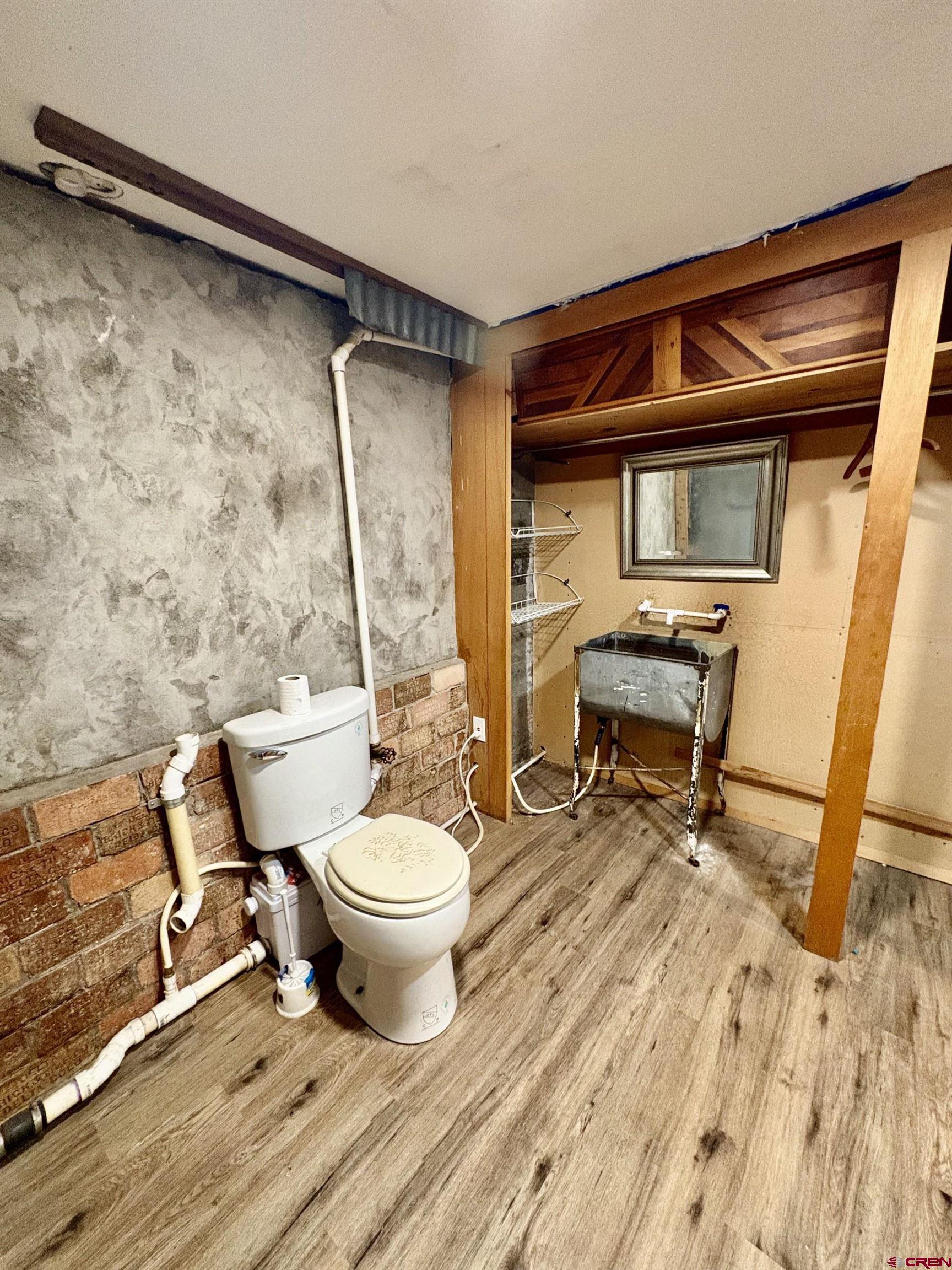 1738 East 7th Street Delta, CO 81416 - Photo 34 of 38 a bathroom with a toilet and a shower
