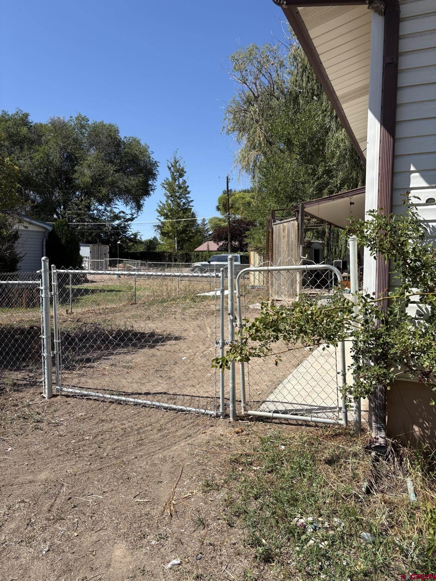 1738 East 7th Street Delta, CO 81416 - Photo 4 of 38 a view of a house with backyard and trees