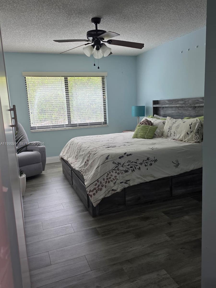 893 Southwest 120th Way Davie, FL 33325 - Photo 19 of 22 a bedroom with a bed and a window
