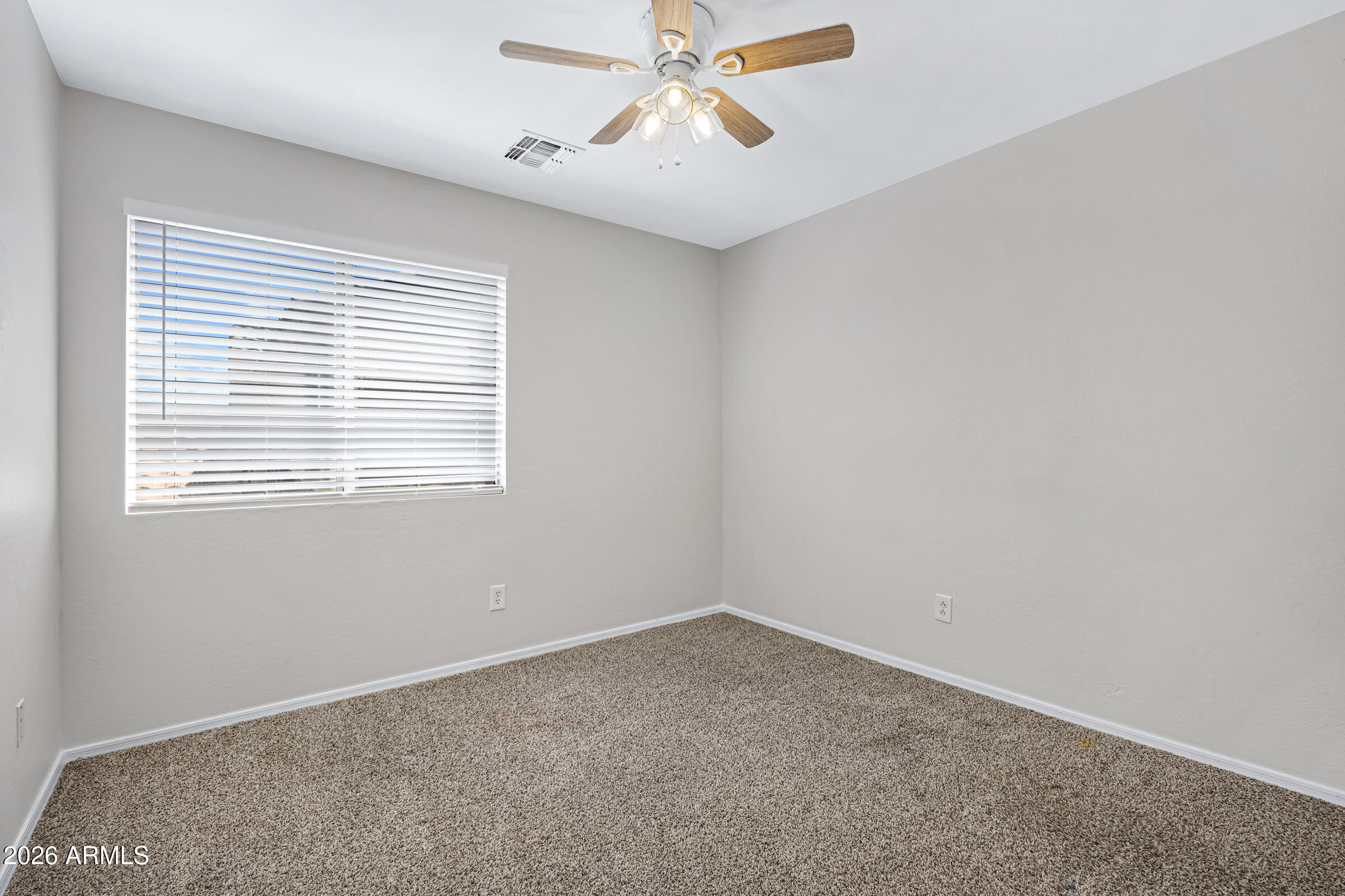 19408 North Braden Road Maricopa, AZ 85138 - Photo 44 of 51 an empty room with a window and a fan