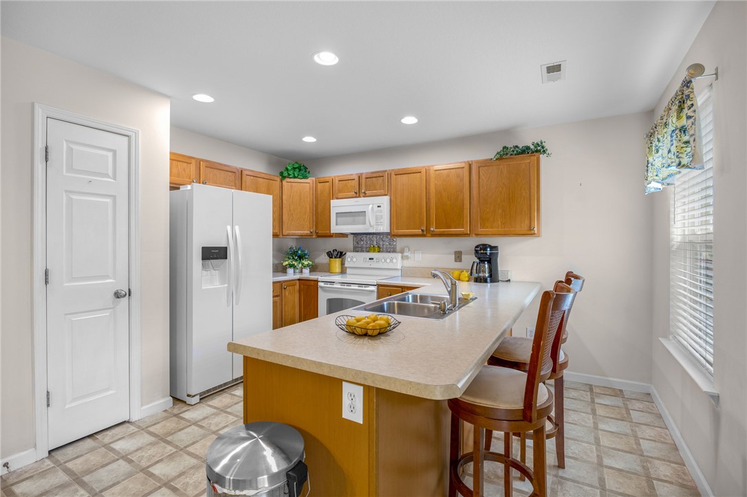 125 Patagonia Road Anderson, SC 29625 - Photo 9 of 36 Ample wooden cabinetry and recessed lighting define this functional culinary space with a breakfast bar.