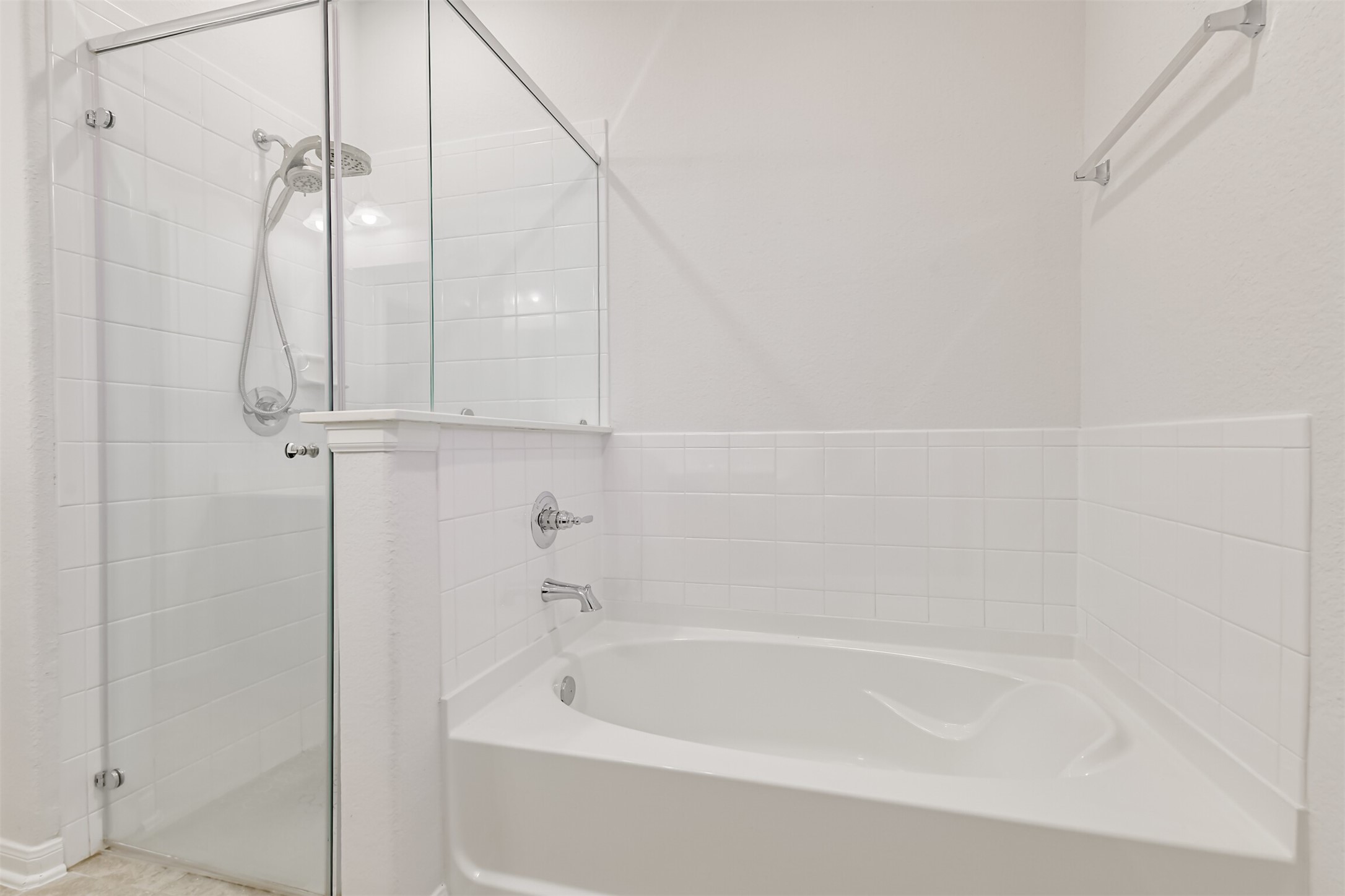 2129 Solstice Boulevard Spring, TX 77386 - Photo 29 of 49 Primary Bathroom:
Bright primary bath featuring a relaxing soaking tub and a separate glass-enclosed shower. Clean white tile surrounds and neutral finishes create a fresh, spa-like feel.