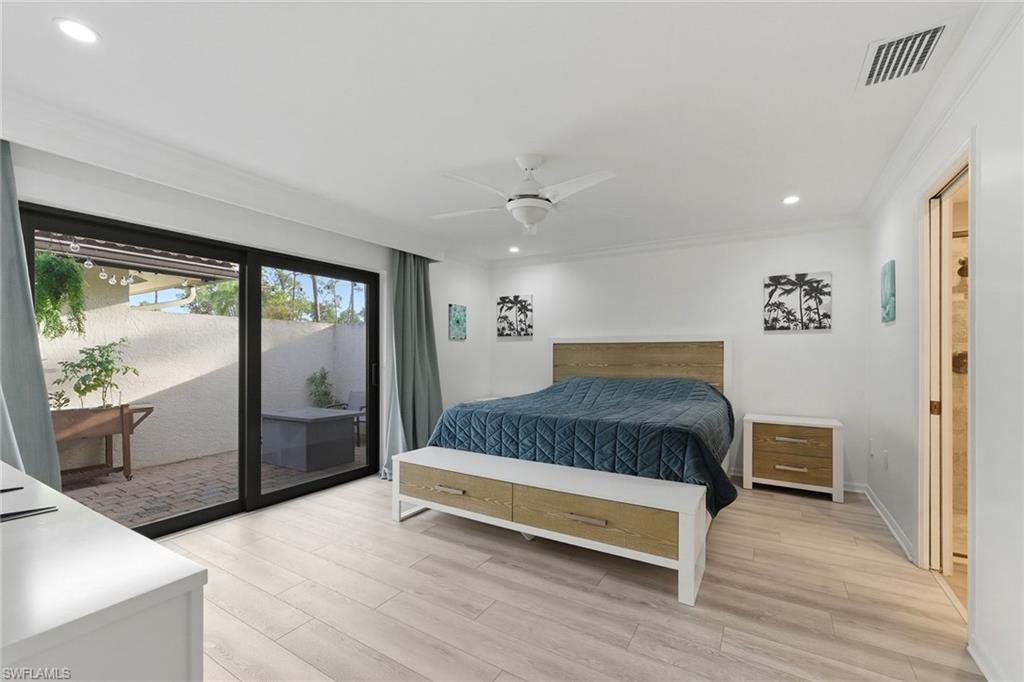 646 Augusta Boulevard Naples, FL 34113 - Photo 24 of 43 a spacious bedroom with a bed and large window