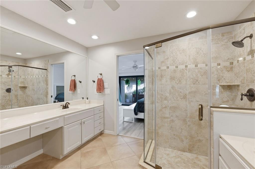 646 Augusta Boulevard Naples, FL 34113 - Photo 28 of 43 a spacious bathroom with a double vanity sink mirror and shower