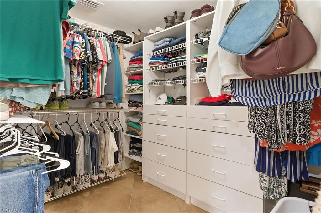 646 Augusta Boulevard Naples, FL 34113 - Photo 29 of 43 a view of walk in closet with clothes