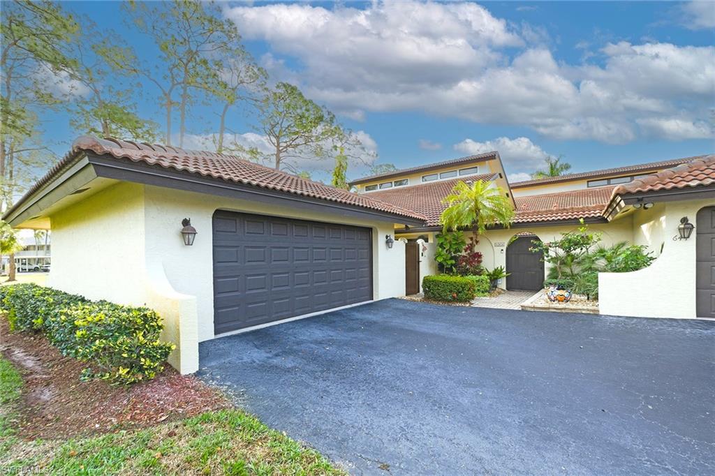 646 Augusta Boulevard Naples, FL 34113 - Photo 3 of 43 a view of a house with a yard and garage
