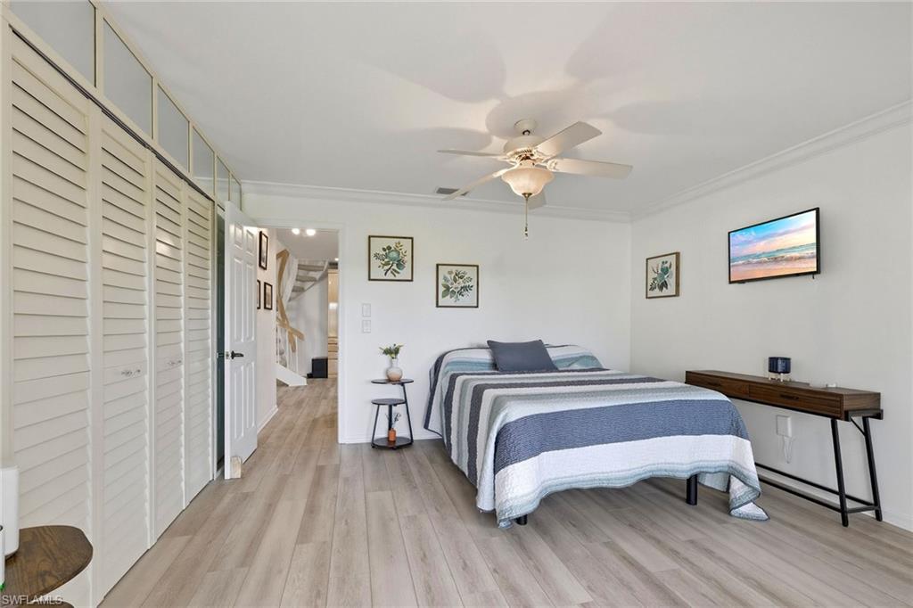 646 Augusta Boulevard Naples, FL 34113 - Photo 31 of 43 a bedroom with a bed and a chandelier