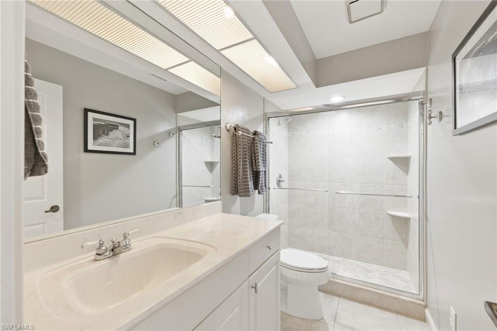 646 Augusta Boulevard Naples, FL 34113 - Photo 32 of 43 a bathroom with a sink a toilet and shower
